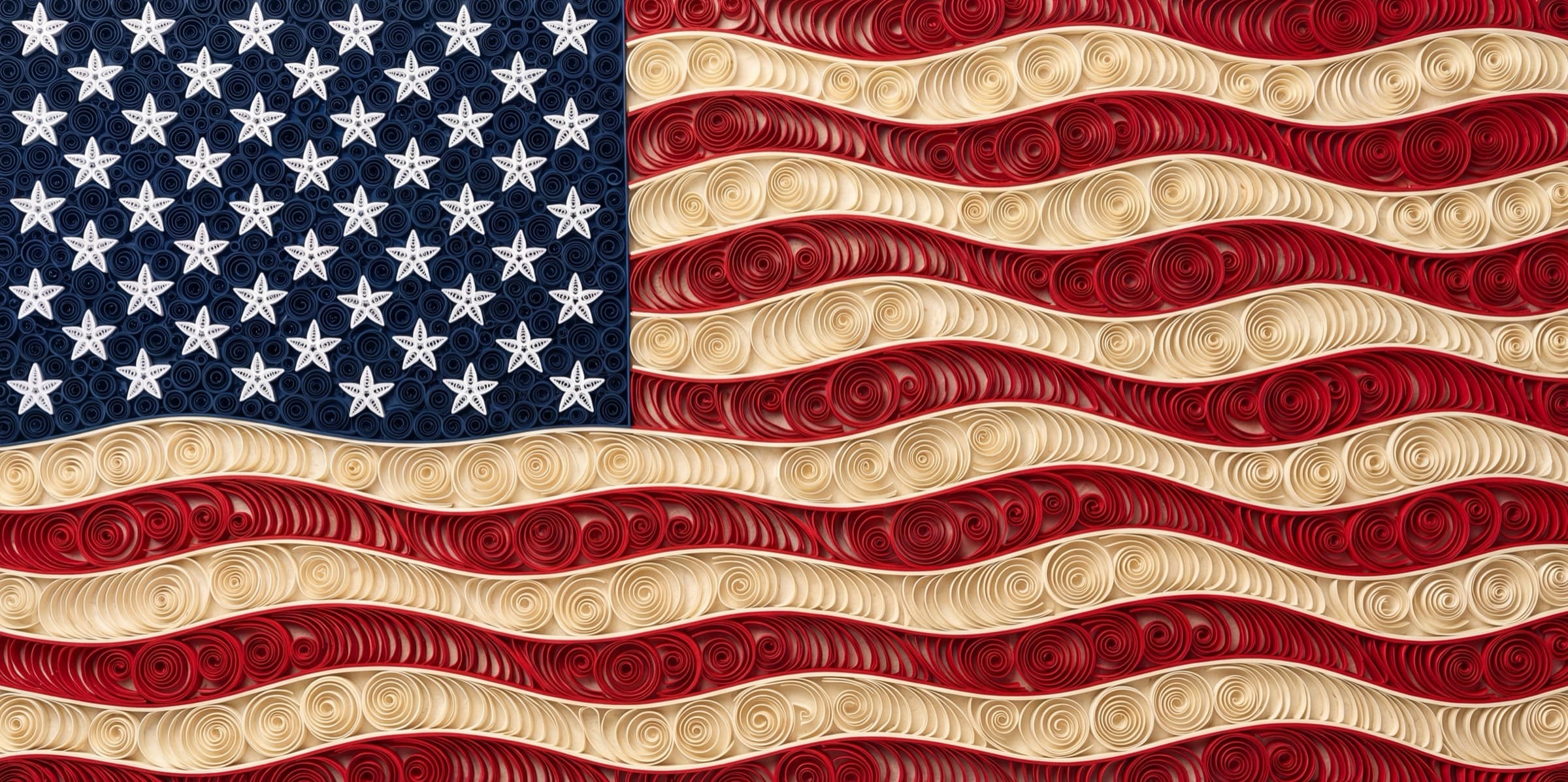 A waving American flag rendered in paper quilling